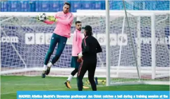  ??  ?? MADRID: Atletico Madrid’s Slovenian goalkeeper Jan Oblak catches a ball during a training session at the Vicente Calderon Stadium in Madrid yesterday on the eve of the UEFA Champions League group C. —AFP