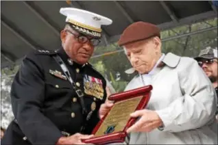  ?? ANNE NEBORAK – DIGITAL FIRST MEDIA ?? Retired General Ronald Coleman, USMC, a native of Darby, presents an award of appreciati­on to World War II Veteran Joseph Cassizzi of Drexel Hill. He is 96 years old.