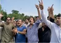  ?? AFP ?? Supporters of Pakistan Tehreek-i-Insaf shout slogans against Prime Minister Nawaz Sharif after the Supreme Court verdict outside the court building in Islamabad on Thursday. —