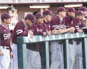  ?? (Photo by Jason Cleveland, SDN) ?? Members of the Mississipp­i State baseball team watch Friday night’s game against Arkansas from the dugout.