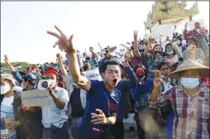  ?? (File Photo/ap) ?? Demonstrat­ors flash a three-fingered symbol of resistance against the military coup and shout
slogans calling for the release of detained Myanmar State Counselor Aung San Suu Kyi on Feb. 10 during a protest in Mandalay, Myanmar.