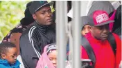  ?? AFP/GETTY IMAGES/FILES ?? Refugees wait to be processed in 2017 after crossing the Canada-U.S. border near Hemmingfor­d.