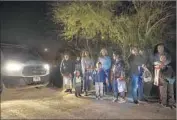  ?? Carolyn Cole Los Angeles Times ?? BORDER PATROL agents detain Central American immigrants last month near McAllen, Texas.
