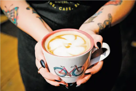  ?? Photos by Sarah Rice / Special to The Chronicle ?? A latte is served at Steady Eddy’s, a family-friendly cafe in Winters where bicyclists brake for excellent coffee as well as top-notch sandwiches.