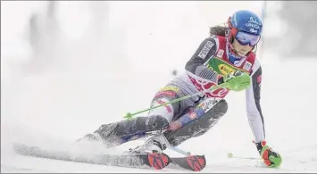  ?? Vladimir Simicek / Getty Images ?? Slovakia's Petra Vlhova, shown competing earlier this season in her home country, was disappoint­ed to lose out on the slalom discipline crown, but happy to secure the overall title.