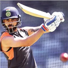  ??  ?? India’s cricket captain Virat Kohli defends against a ball during a training session in Perth. — AFP photo