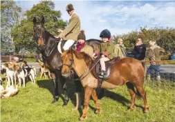  ??  ?? Whipper-in Mark (Bonny) Langford with his partner, Chloe Campbell, and their daughter, Olivia Langford