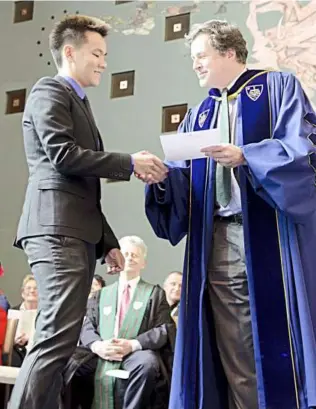  ??  ?? Trinity’s Prof Andrew McGowan congratula­ting a student during a farewell ceremony.