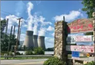  ?? JOHN RABY — ASSOCIATED PRESS ?? American Electric Power’s John Amos coal-fired plant in Winfield, W.Va., is seen from the town of Poca across the Kanawha River in a photo taken last month.