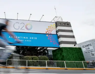  ??  ?? A cyclist passes Costa Salguero Exhibition Center in Buenos Aires, Argentina, the venue of the 13th G20 summit held from November 30 to December 1, 2018. Xinhua