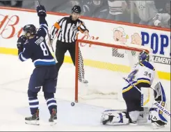  ?? Canadian Press photo ?? Winnipeg Jets' Jacob Trouba scores the game winning goal on St. Louis Blues goaltender Jake Allen during overtime NHL hockey action in Winnipeg, Monday.