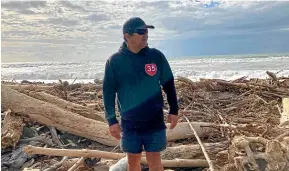  ?? TONY WALL/STUFF ?? Graeme Atkins amidst the tonnes of slash on Te Wharau Beach. He says landscape protection has to be a priority given the repeated cycle of storm and destructio­n.