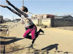  ?? / THULANI MBELE ?? Children play skipping with a self-made rope in the streets of one of the oldest townships in the country.