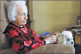  ?? [JOSHUA A. BICKEL/DISPATCH] ?? Sarah Lilly pets her dog, Katy.