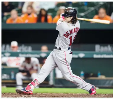  ??  ?? Boston Red Sox left fielder Andrew Benintendi hits a two-run RBI single in the 11th inning against the Baltimore Orioles at Oriole Park at Camden Yards on Monday. The Red Sox defeated the Orioles 10-8. (USA TODAY Sports)