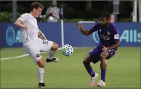  ?? AP PHOTO JOHN RAOUX ?? Inter Miami defender Mikey Ambrose (33) and Orlando City defender Ruan vie for the ball during the first half of an MLS soccer match Wednesday in Kissimmee, Fla.