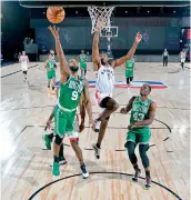  ?? — AFP ?? Brad Wanamaker (left) of the Boston Celtics drives to the basket during their game against the Toronto Raptors in Orlando, Florida, on Friday.