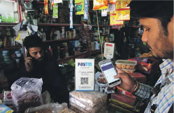  ?? EPA ?? A stationery shop in Bhopal, India. Paytm controls about half of the local payment market while Google Pay has a market share of 10 per cent, according to a report by consultanc­y RedSeer