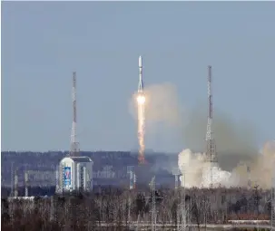  ?? (Roscosmos/handout via Reuters) ?? A SOYUZ-2.1B rocket booster carrying Iran’s newest satellite blasts off yesterday from a launchpad at the Vostochny Cosmodrome in Russia’s far eastern Amur region.