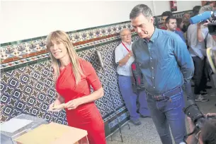  ?? REUTERS ?? Spain’s Socialist leader and Prime Minister Pedro Sanchez looks on as his wife Begona Gomez votes during the general snap election in Madrid, Spain, in this file photo on July 23.