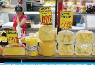  ?? — AFP ?? BUENOS AIRES: Signs show the price of the different cheeses at the Central Market in Buenos Aires.