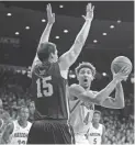  ??  ?? Arizona center Chase Jeter, right, shoots the ball as Houston Baptist center Edward Hardt defends during the first half Wednesday at the McKale Center in Tucson.CASEY SAPIO/USA TODAY SPORTS