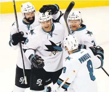  ?? DAVID ZALUBOWSKI/ASSOCIATED PRESS ?? Patrick Marleau, second from left, is greeted by David Schlemko, from left, Paul Martin and Joe Pavelski after his third goal.