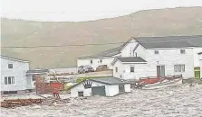  ?? MICHAEL KING VIA AFP/GETTY IMAGES ?? Fiona wreaked havoc on the Burnt Islands, in the Newfoundla­nd and Labrador, Canada, knocking out power to more than 500,000 households.