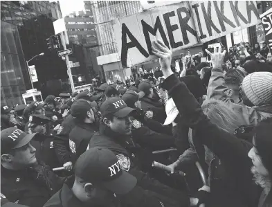  ?? KENA BETANCUR/AFP/GETTY IMAGES ?? Police officers block demonstrat­ors during a protest against U.S. president-elect Donald Trump last week in New York. Non-white voters, who represent 30 per cent of the electorate, went 74 per cent for Hillary Clinton in the election.