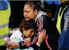  ?? REBECCA BLACKWELL PHOTOS / AP ?? Family members embrace as they wait for news of their relatives outside a building in Mexico City’s Roma Norte neighborho­od Friday. Officials are promising to keep up the search for quake survivors as rescue operations continue.