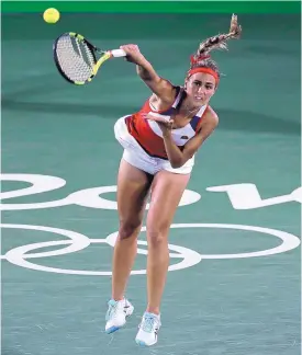  ?? CHARLES KRUPA/ASSOCIATED PRESS ?? Monica Puig serves to Angelique Kerber during the recently concluded Summer Olympics. Puig won the gold medal, and she is seeded 32nd for the U.S. Open.