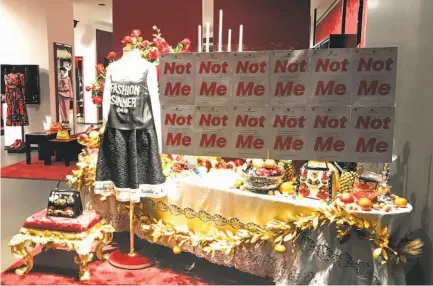  ?? Edward Gu / AFP / Getty Images ?? A protest banner appears on the window of a Dolce &amp; Gabbana store in Shanghai amid the brand’s controvers­y.