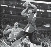  ?? Jae C. Hong Associated Press ?? THE CLIPPERS’ Josh Smith gets a rebound as Houston’s Dwight Howard watches during first half.