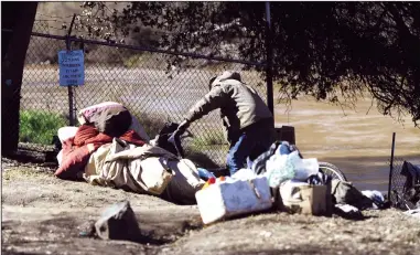  ?? NEWS-SENTINEL FILE PHOTOGRAPH ?? A homeless person is seen at an encampment near Highway 99 and Turner Road in this 2019 photo. On Monday, a team with the San Joaquin County Sheriff’s Department was cleaning up a site when they were served a cease and desist order from Caltrans.