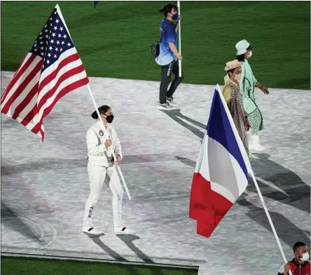  ?? VINCENT THIAN - THE ASSOCIATED PRESS ?? Kara Winger, of the United States of America, and Steven Da Costa, of France, carry their country’s flags during the closing ceremony in the Olympic Stadium at the 2020Summer Olympics, Sunday, Aug. 8, 2021, in Tokyo, Japan.