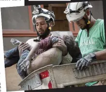  ??  ?? Victim: Rescuers carry the body of a young girl from a bombed building