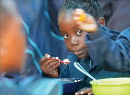  ?? PICTURE: INDEPENDEN­T MEDIA ARCHIVES ?? FOOD DAY: Simthandil­e Gazmana, 6, from Gugulethu, enjoys a bowl of cereal at Surrey Primary school during Food Day.