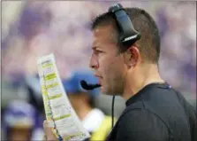  ?? BRUCE KLUCKHOHN — THE ASSOCIATED PRESS FILE ?? Vikings offensive coordinato­r John DeFilippo looks at his play sheet during a game against the Bills in Minneapoli­s. The Jaguars have hired DeFilippo, a Radnor High School graduate and former Eagles assistant, to the same position.