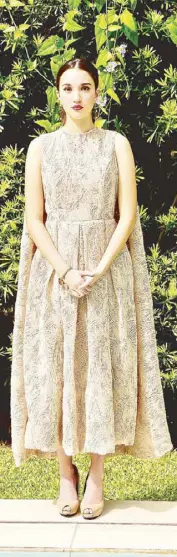  ??  ?? Beige dress made of point d’esprit lace with cape at the back by Therese Andaya.