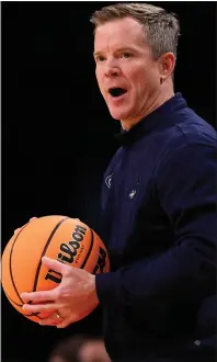  ?? SARAH STIER — GETTY IMAGES ?? In what turned out to be his final game as Florida Atlantic head coach, Dusty May looks on in Friday’s NCAA Tournament loss to Northweste­rn. Michigan has named May its next head coach.