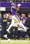  ?? Associated Press photo ?? Minnesota Vikings wide receiver Stefon Riggs (14) makes a catch over New Orleans Saints free safety Marcus Williams (43) on his way to the game winning touchdown during the second half of an NFL divisional football playoff game in Minneapoli­s, Sunday.