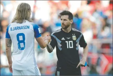  ?? The Associated Press ?? A POINT APIECE: Argentina’s Lionel Messi, right, shake hands with Iceland’s Birkir Bjarnason at the end of their 1-1 draw in a Group D match of the 2018 FIFA World Cup Saturday in the Spartak Stadium in Moscow, Russia.