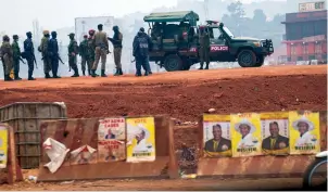  ?? The Associated Press ?? ■ Security forces gather Thursday in Kampala, Uganda.