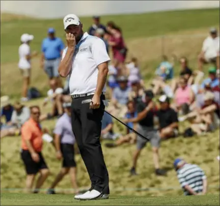  ?? DAVID J. PHILLIP - THE ASSOCIATED PRESS ?? Marc Leishman, of Australia, watches his putt on the ninth hole during the fourth round of the U.S. Open golf tournament Sunday at Erin Hills in Erin, Wis.