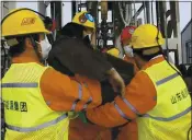  ?? LUAN QINCHENG — XINHUA VIA AP ?? Rescuers on Sunday carry a miner who was among 11 trapped in a gold mine for two weeks in Qixia City in east China’s Shandong Province.