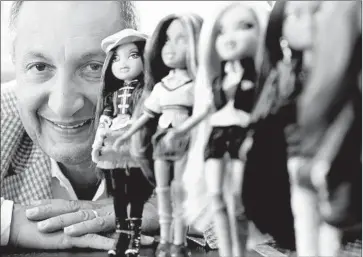  ?? Christina House Los Angeles Times ?? ISAAC LARIAN, chief executive of MGA Entertainm­ent, poses in 2010 with the company’s line of Bratz dolls. His bid for more than 350 Toys R Us stores in North America will have to be evaluated in Bankruptcy Court.