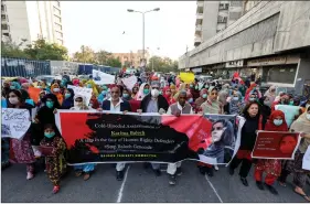  ?? REUTERS ?? People carry a banner and placards to condemn the death of Karima Baloch, a Baloch human rights activist living in Canada, who went missing and was found dead, during a protest in Karachi, Pakistan on Thursday.