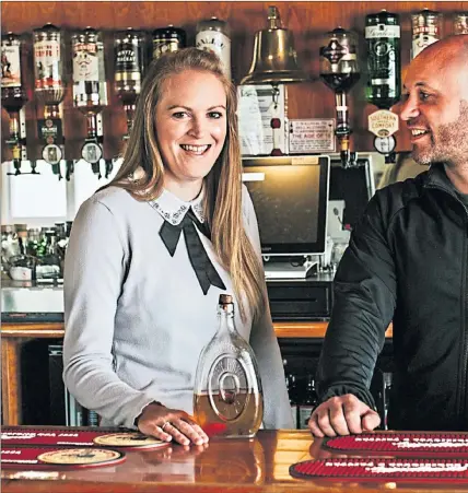 ??  ?? Co-owners Julia and Stephen Campbell, behind the bar of the Am Politician on Eriskay, are ready to welcome back locals and tourists