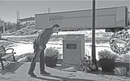  ?? PHOTOS BY ANGELA PETERSON / MILWAUKEE JOURNAL SENTINEL ?? Ron Knebel pays his respects at a memorial to the victims of the Molson Coors shooting on Friday, the anniversar­y of the shooting. Knebel, an employee with Molson Coors, drove from Chicago to remember the lives lost. “There is a deep sense of sorrow from the whole Molson family,” he said.