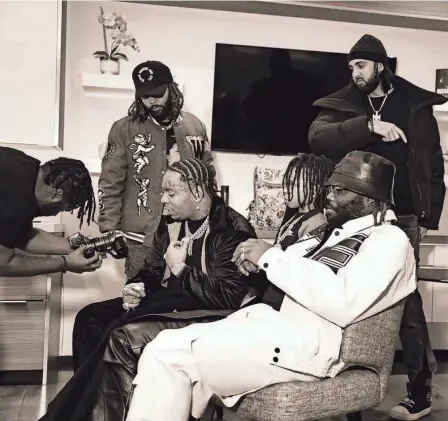  ?? PROVIDED BY DELVIN YOUNG ?? Memphis music producer Hitkidd (seated, right) with Lil Gotit (seated, left) prior to the release of their collaborat­ive single "Secluded." The song released April 12.